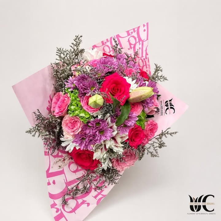Lush pink and purple mixed-flower bouquet in decorative wrapping