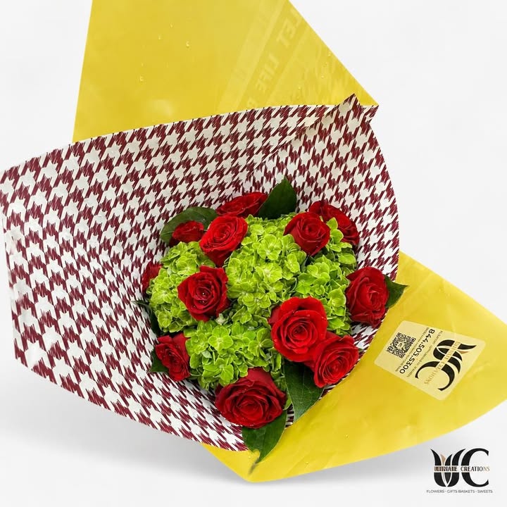 Red roses and green hydrangeas wrapped in yellow patterned paper