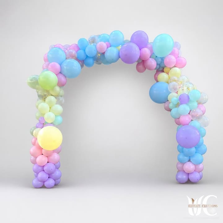 Pastel balloon arch framing a building entrance