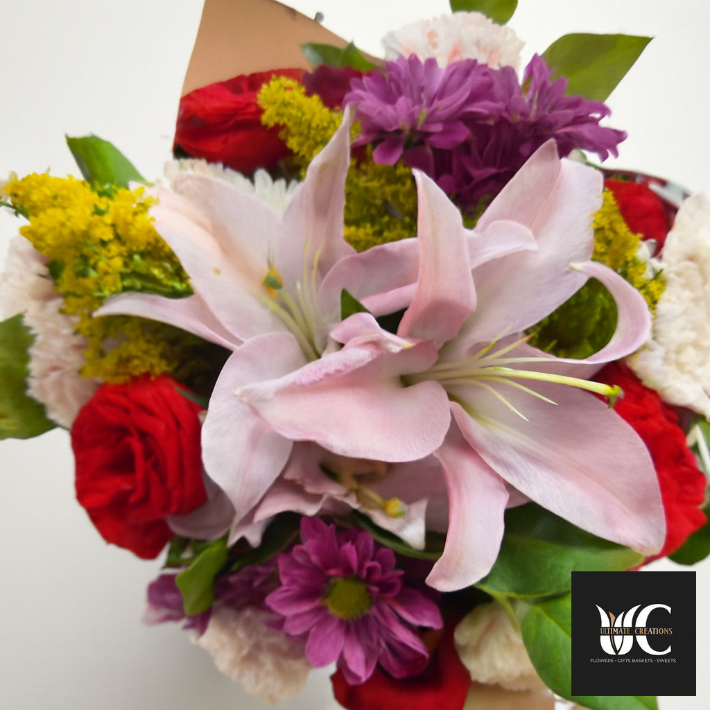 Colorful mixed bouquet with pale pink lilies, red, purple, yellow, and white flowers.