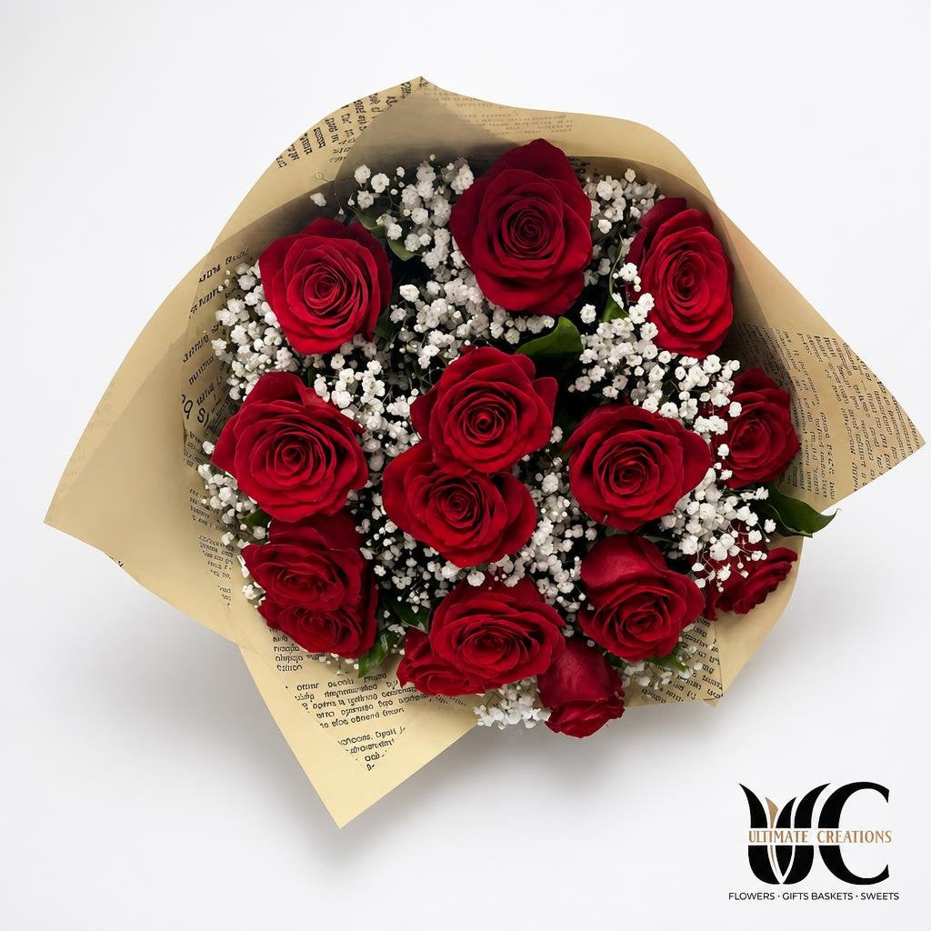 Bouquet of red roses with baby's breath wrapped in kraft paper.