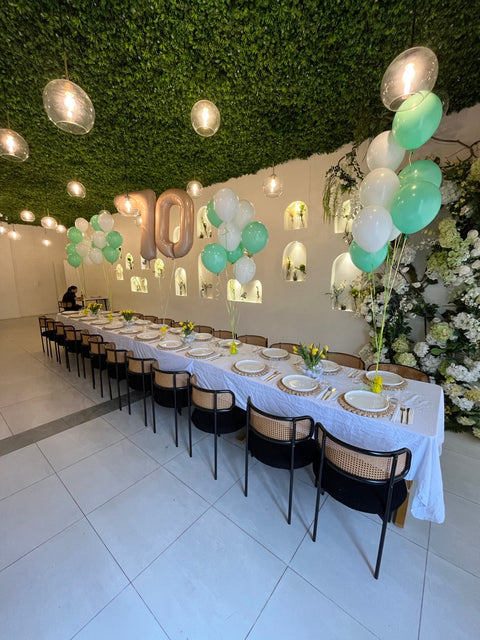Golf-themed 70th birthday celebration at Posh Pizza and Restaurant in Queens NY with mint balloons, rose-gold 70 balloons and yellow tulip centerpieces