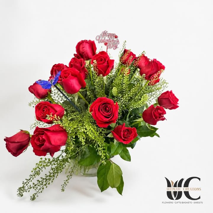 Lush red rose bouquet with greenery, blue butterfly accent, and Valentine’s Day sign