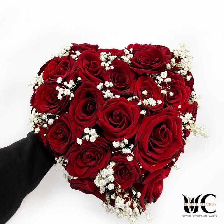 Round bouquet of red roses with white filler flowers