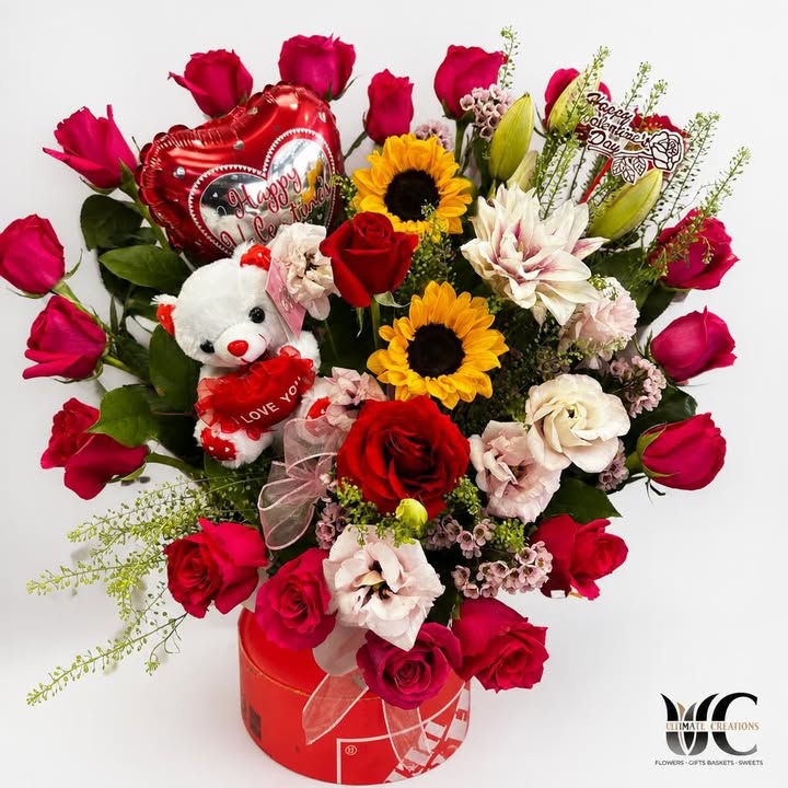 Valentine’s floral gift box with roses, sunflowers, teddy bear, and heart balloon