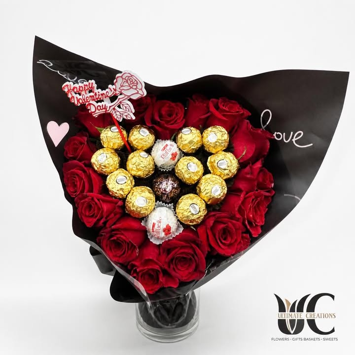 Red rose and chocolate bouquet wrapped in black paper with heart accents