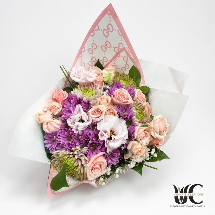Pastel pink and lavender flower bouquet wrapped in layered paper