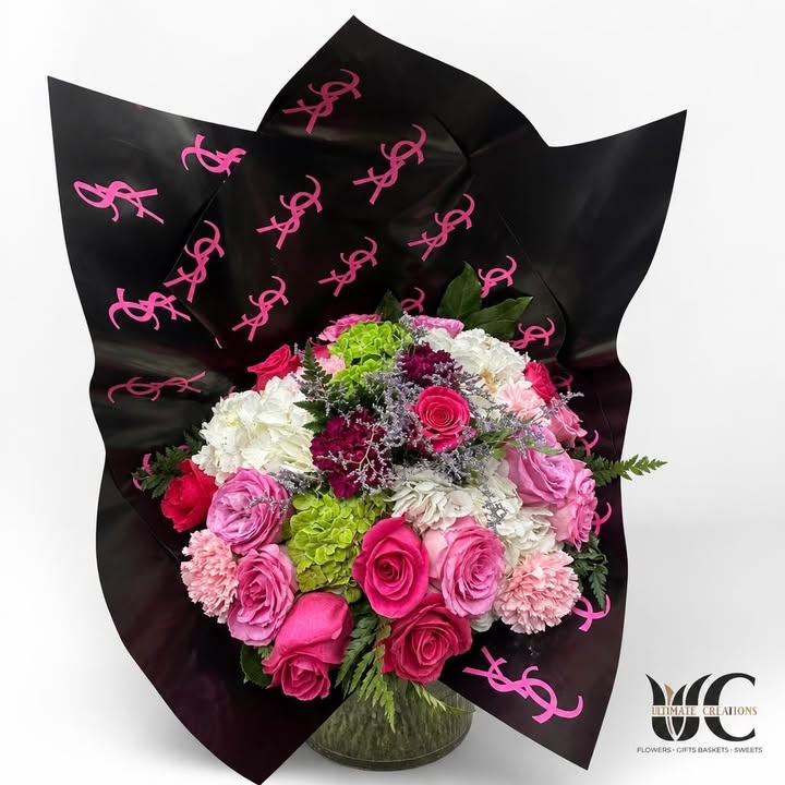 Lush pink and green bouquet in black printed wrapping