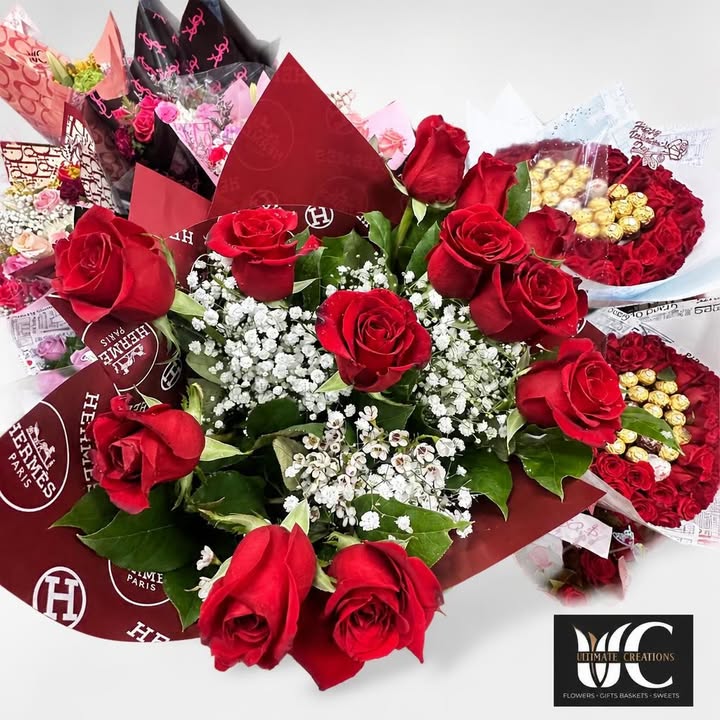 Red rose bouquet with white filler flowers, greenery, and decorative wrapping