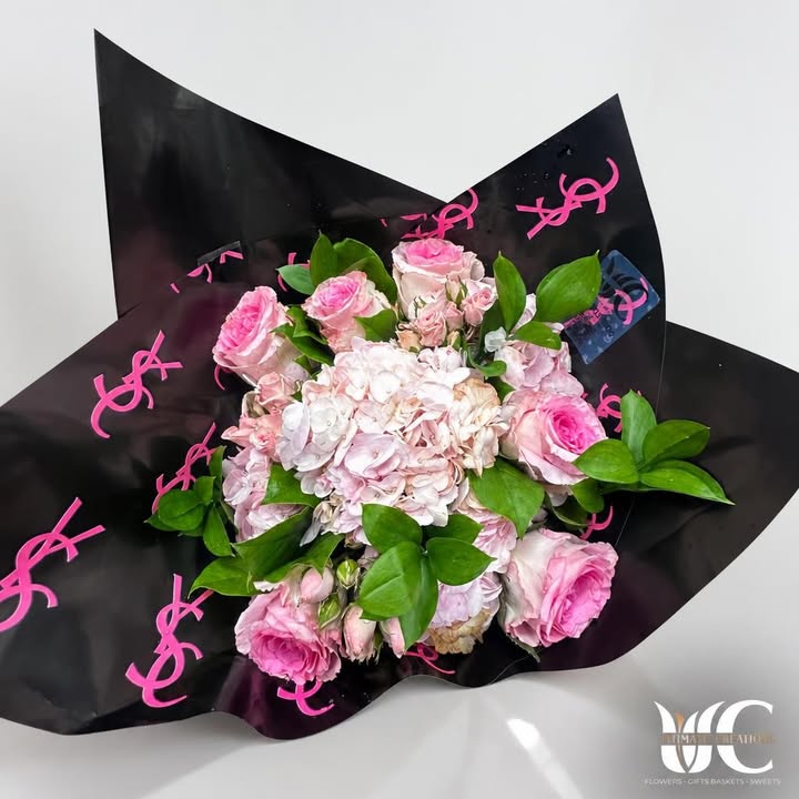 Pink and white bouquet with greenery in black wrapping