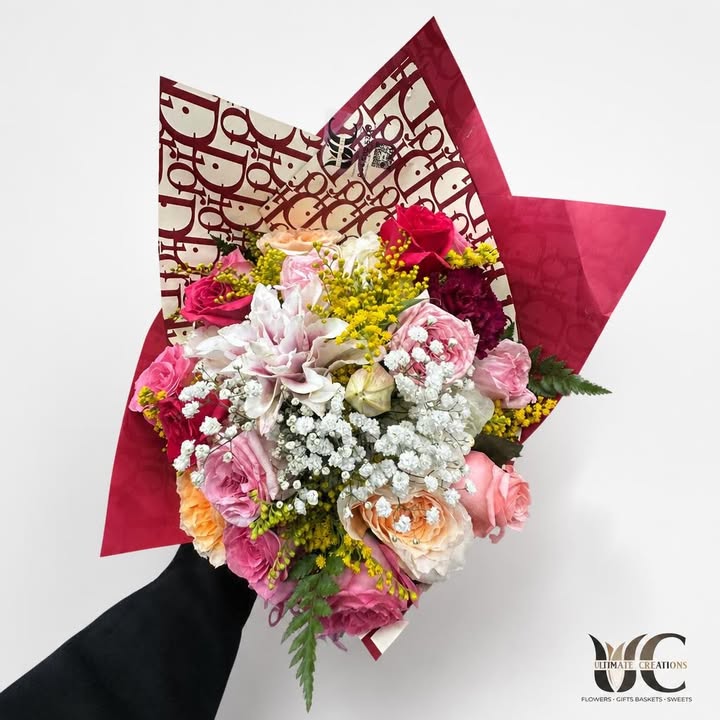 Lush multicolor bouquet wrapped in burgundy and cream paper