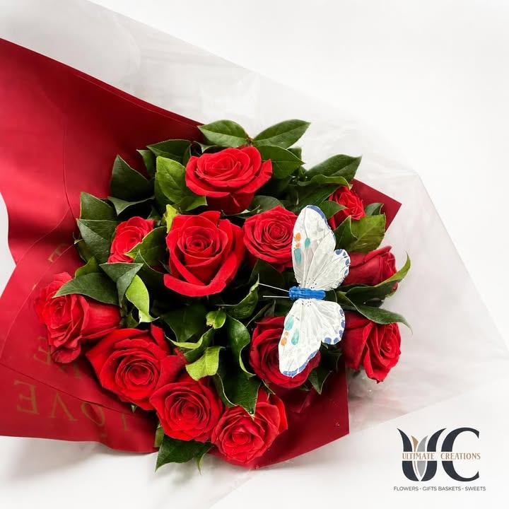 Red rose bouquet with greenery, red wrap, and a white-blue butterfly accent
