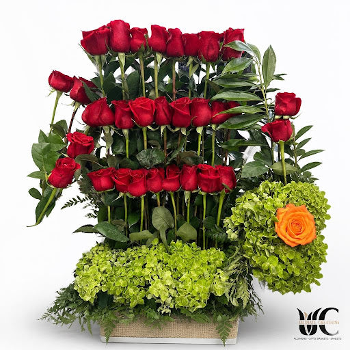 Layered red roses with green clustered blooms and foliage.