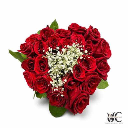 Rounded red rose bouquet with white filler flowers and green leaves.