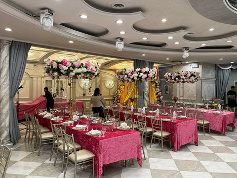 Full-room engagement party decor at King David Restaurant featuring pink table linens, gold centerpiece stands and lush pink-and-white florals by Ultimate Creations NY.