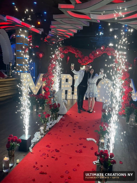 DJ Israel engagement proposal at Oligarch Catering Hall in Queens, NY with red rose heart arch, MARRY ME letters and cold sparks by Ultimate Creations NY.
