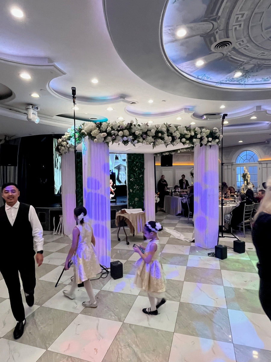 White draped Jewish wedding canopy with a lush white and lavender floral garland at King David Catering Hall in Forest Hills, Queens