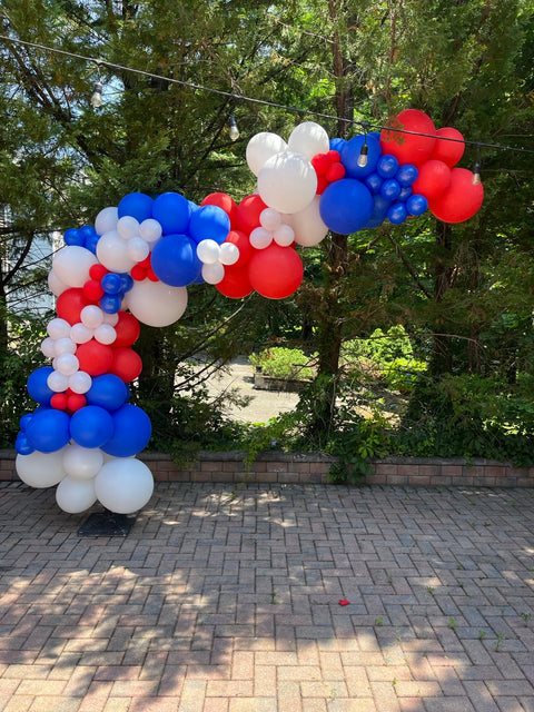 Fourth of July backyard balloon arch in red, white and blue for a private Long Island house party by Ultimate Creations NY.