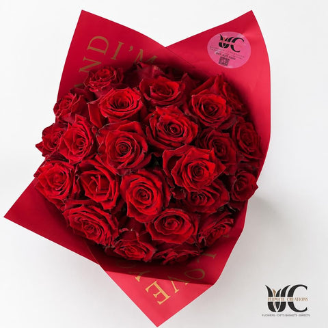 Abundant bouquet of red roses in vivid red decorative wrap