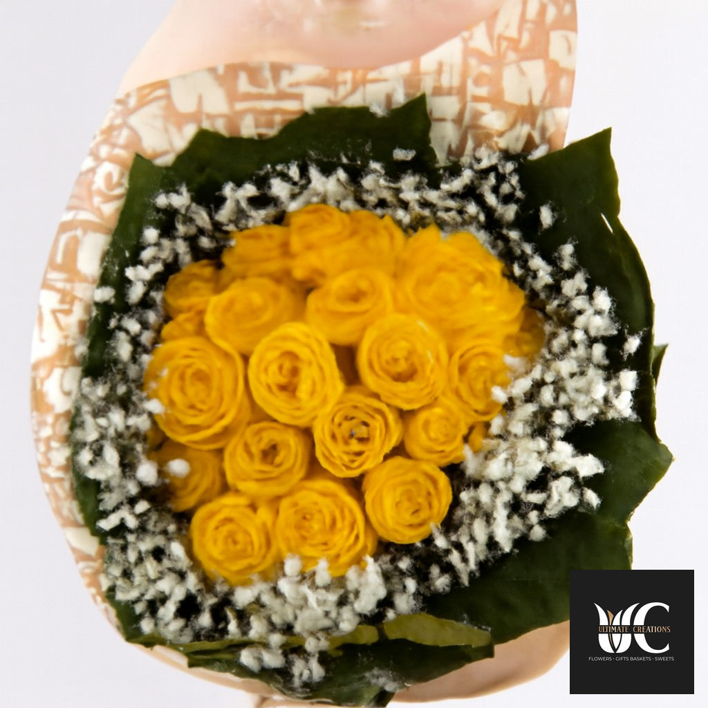 Hand-tied bouquet of yellow roses surrounded by white baby’s breath and green leaves.