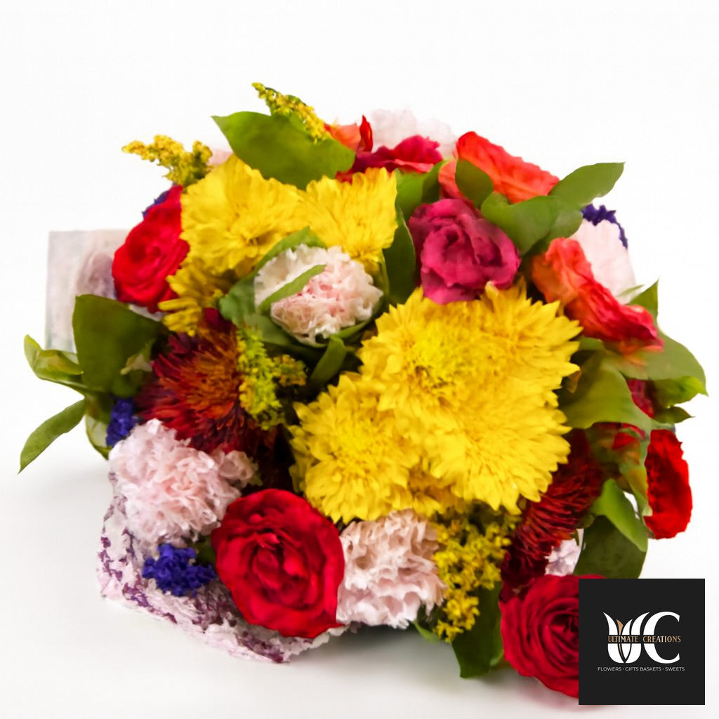 Colorful mixed bouquet with yellow, red, pink, orange, and purple flowers and green leaves on a white background.