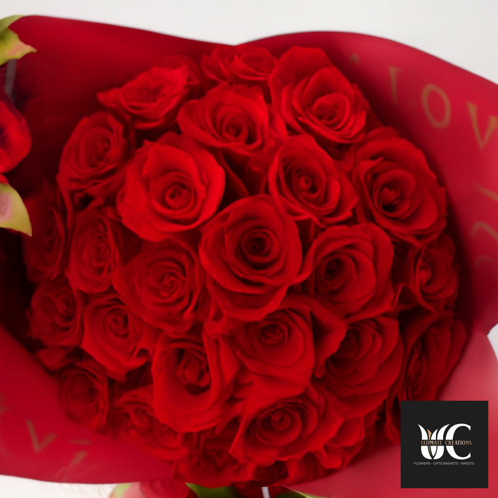 A tightly packed bouquet of red roses wrapped in red paper.