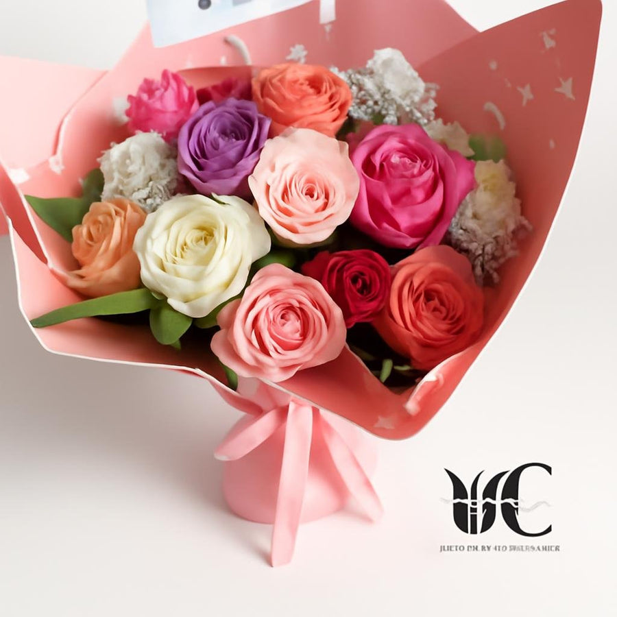 Hand-tied bouquet of pastel roses wrapped in pink paper with a ribbon.