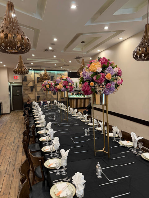 Sheva Brachot dinner setup with tall gold floral centerpieces, black linens and white place settings by Ultimate Creations NY