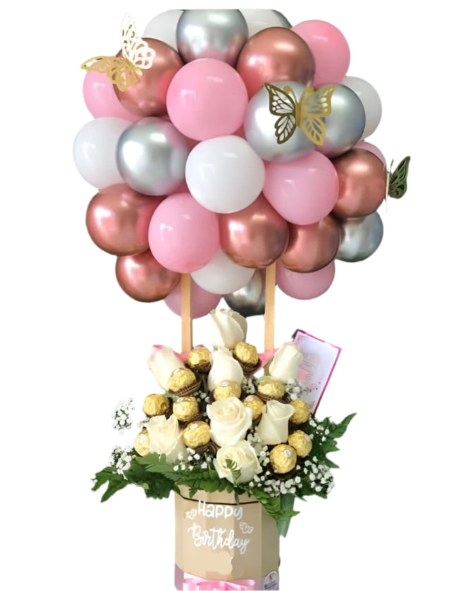 Balloon arrangement with flowers and a card on a green background
