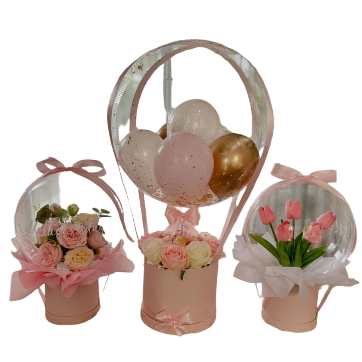 Decorative setup with pink balloons and flower arrangements on a textured surface.