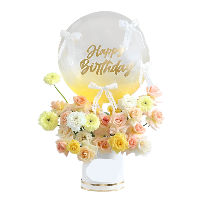 Decorative bubble with flowers and 'Happy Birthday' text on a white surface.