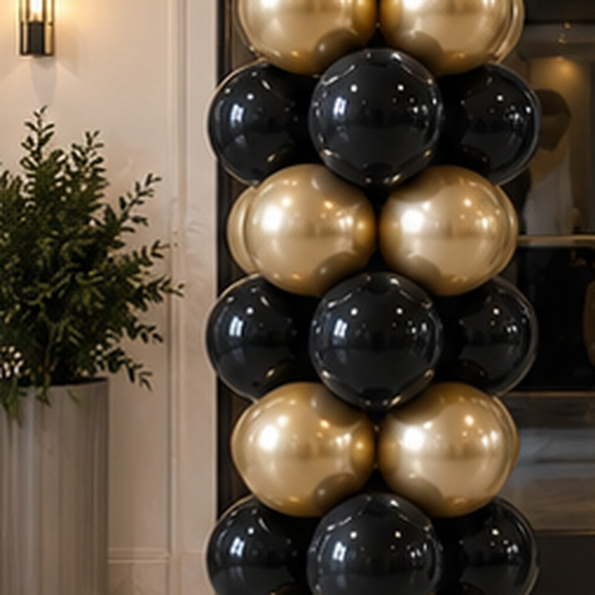 Close view of a premium classic balloon column with metallic gold and black balloons