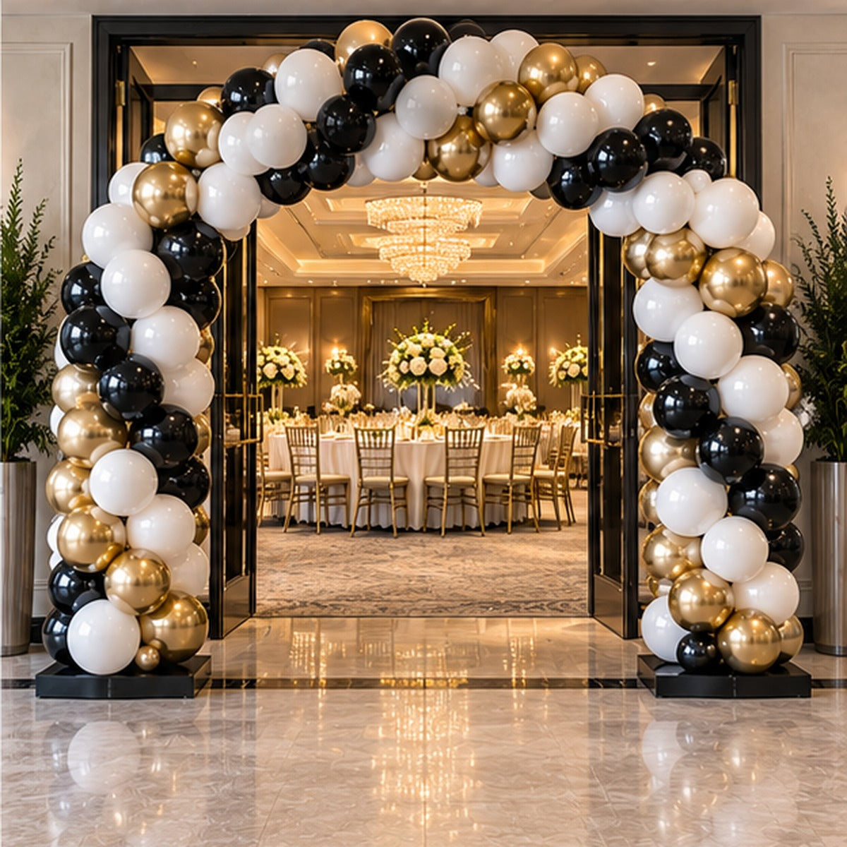 Classic premium black white and gold balloon entrance arch at an elegant event venue