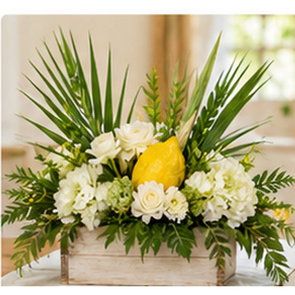 Classic Sukkot table centerpiece with white flowers, greenery and decorative seasonal accents