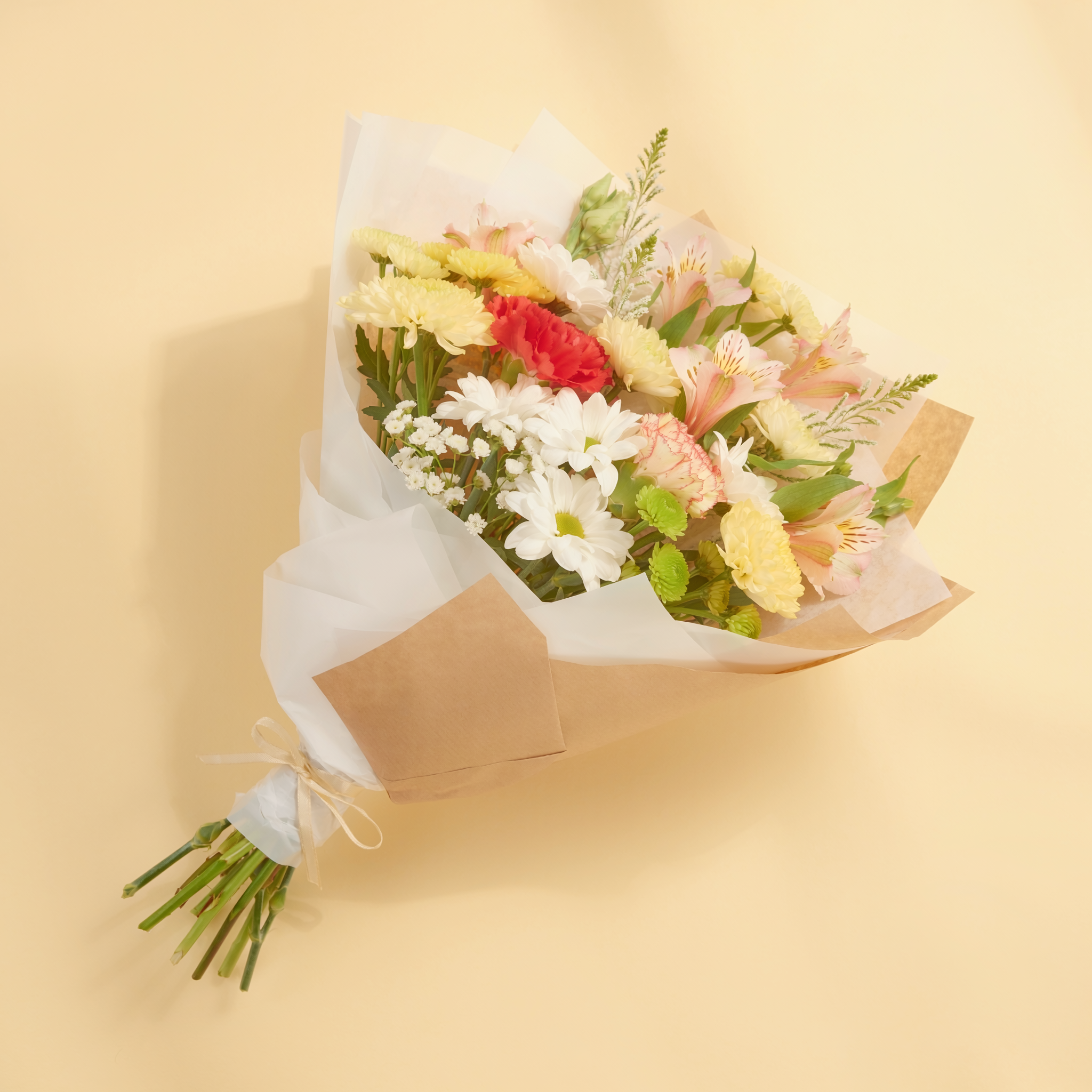 Top view of a cheerful mixed seasonal $25 hand-tied bouquet
