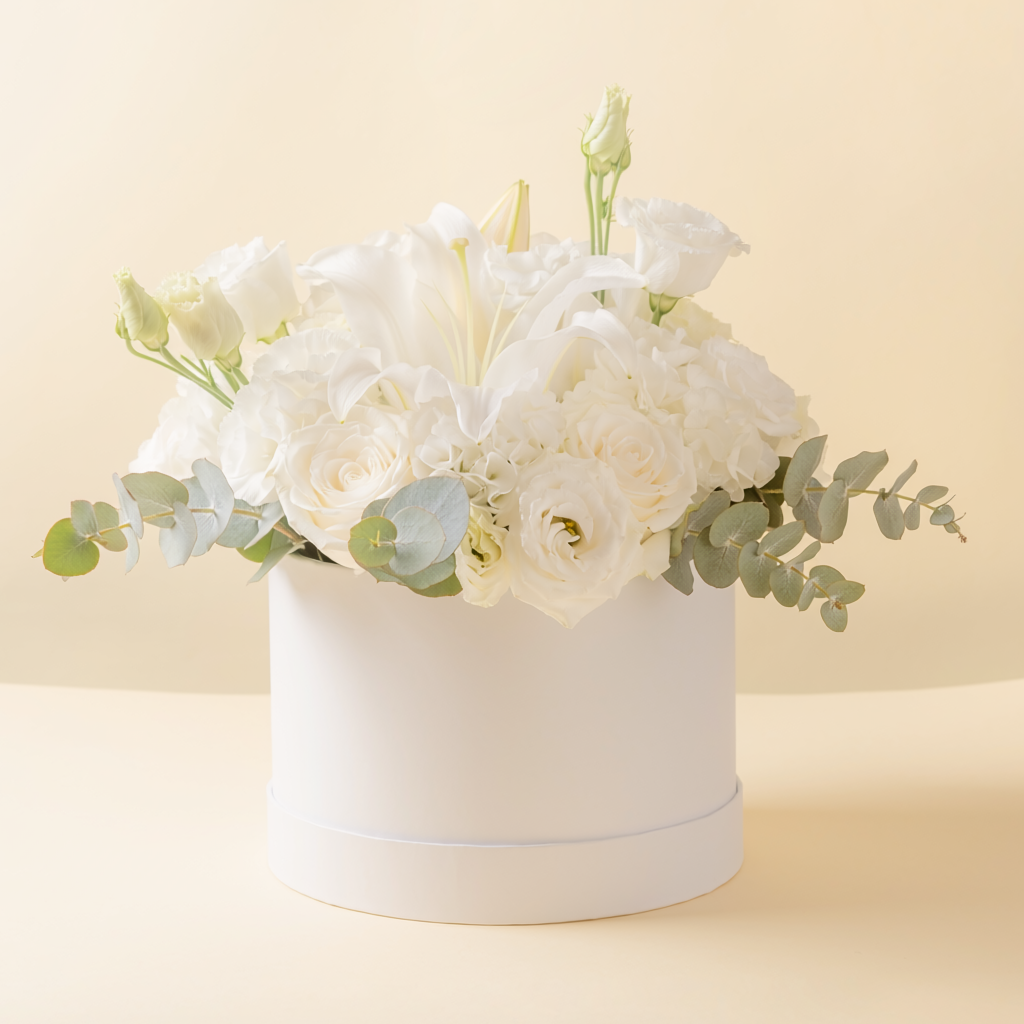 Peaceful white and green sympathy flower arrangement in a box